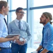 Group of contemporary businessmen discussing plans in office ?????????????????????????????????????
